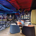Fitness Center Lounge With Modern Industrial Design Blue Red Pipes Grid Ceiling And Comfortable Sofas