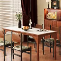 Cozy Restaurant Dining Area With Wooden Table Upholstered Chairs And Fruit Bowl