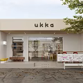 Modern White Café Exterior With Glass Doors Outdoor Bench And Fallen Leaves