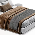 Modern Bedroom Bed With White And Brown Pillows Gray Knit Blanket And Round Side Table
