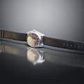 Elegant Watch Featuring Silver Dial Black Leather Strap and Metal Buckle on Black Reflective Surface