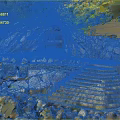 Natural Rocky Cliffside with Cave Entrance Stone Steps and Waterfront Green Vegetation