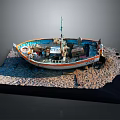 Wooden Boat Model with Orange White Hull on Coastal Display Base and Sand Water Elements
