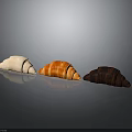 Three Different Colored Croissants White Butter And Chocolate On Dark Background