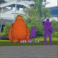 Giant Red Plant Shaped Garden Ornament with People Taking Photos in Outdoor Park