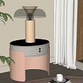 Modern Bedside Table With Black Top Gold Lamp And Green Plant In Bedroom