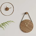 Minimalist Wooden Wall Clocks with Natural Design Hanging on Light Gray Wall and Green Leaf