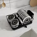 Black Dish Drying Rack With Stacked Plates And Wooden Utensils On Marble Kitchen Countertop