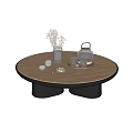 Modern Round Wooden Coffee Table With Black Base Tea Set Vase And Cups On Top
