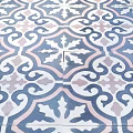 Intricate Patterned Floor Tiles Featuring Swirls and Cross Designs in Blue Pink and White