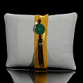 Gray Fabric Pillow With Yellow Strap Green Circular Accent And Tassel