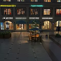 Spring Fair 2024 Commercial Street With Lit Shop Windows Outdoor Seating And Christmas Tree