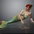 Red Haired Woman In Green And Yellow Mermaid Tail Lying On Black Smooth Surface