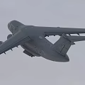 Gray Passenger Airplane Flying With Extended Wings In Overcast Sky