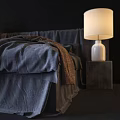 Double Bed with Dark Blue Linen Sheets Brown Blanket and Wooden Nightstands White Lamps