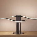 Modern Curved Arm Desk Lamp With LED Light Strips And Black Base On Wooden Table