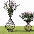 Ornamental Trees In Wicker Vase Shaped Planters With Purple Flowers On Green Lawn