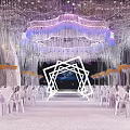 Luxurious Banquet Hall With Crystal Chandeliers White Chairs And Elegant Stage Lighting Design
