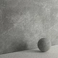 Gray Spherical Component With Textured Surface Against Gray Wall Background