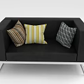 Black Sofa With Silver Metal Legs And Three Decorative Striped Geometric Pillows