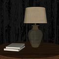 Stylish Table Lamp On Round Wooden Table With Two Books Against Dark Wooden Wall Background