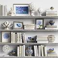 White Bookshelves With Stacked Books Magazines Framed Blue White Art And Decorative Ornaments