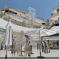 Vibrant Commercial Street With Outdoor Dining Area Umbrellas Seats Shops And Pedestrians