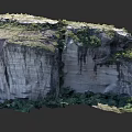 Majestic Natural Stone Rock Formation With Layered Structure And Green Vegetation