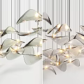 Modern Chandelier with Multiple Leaf Shaped Metallic Pieces and Illuminated Warm Glow for Contemporary Interiors
