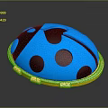 Blue Ladybug Shaped Clothing Accessory With Black Spots And Golden Border