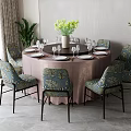 Elegant Round Dining Table With Pink Tablecloth And Blue Floral Upholstered Chairs