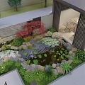 Courtyard Water Fountain with Stones Green Plants and Wooden Leisure Seats