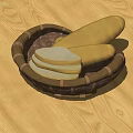 Fresh Loaf of Bread and Sliced Pieces in Wicker Basket on Wooden Table