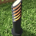 Outdoor Light with Spiral Design and Warm Glow in Green Grass Garden