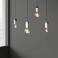 Modern Pendant Lights With Transparent Bulbs Hanging Over Gray Wall And Window Blinds