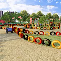 Fun Playground Featuring Colorful Tire Obstacles Sand Ground GO Sign And City Skyline