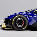 Blue And Yellow Monster Race Car With Aerodynamic Design And Rear Wing