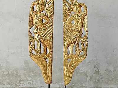 Golden Carved Decorative Ornament Set with Intricate Figures and Patterns Against Grey Wall Background 3d model