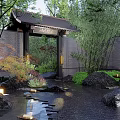Scenic Entrance Gate Surrounded By Lush Trees Pond Wooden Bridge And Lanterns