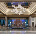 Luxurious Hotel Lobby With Crystal Chandeliers Marble Floor Blue Curtains Orange Chairs And Symmetric Decor