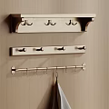 Three Wall Mounted Racks With Hooks Hanging On Wooden Wall And Towel