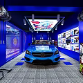 Modern Car Dealership Showroom With Blue Interior Display Car Decorative Posters And Lighting