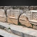 Ancient Stone Carved Architectural Elements With Intricate Floral And Geometric Motifs