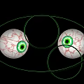 Green Outlined Human Eyes With Red Blood Vessels And Green Pupils On Black Background