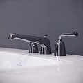 Modern Black And Silver Bathroom Faucet On White Sink With Dark Wall Design