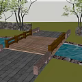 Scenic Landscape Bridge With Wooden Deck Over Stream And Stone Walls In Green Grass Area