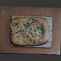 Golden Baked Flatbread With Fresh Herbs And Colorful Toppings On Wooden Tray