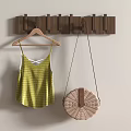 Wooden Wall Mounted Hooks Holding Striped Tank Top And Woven Round Bag