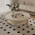Round Light Colored Coffee Table With Wooden Legs Vase White Flowers Books And Small Cups