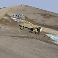 Active Construction Site With Yellow Excavator Working On Dirt Ground And White Pipes